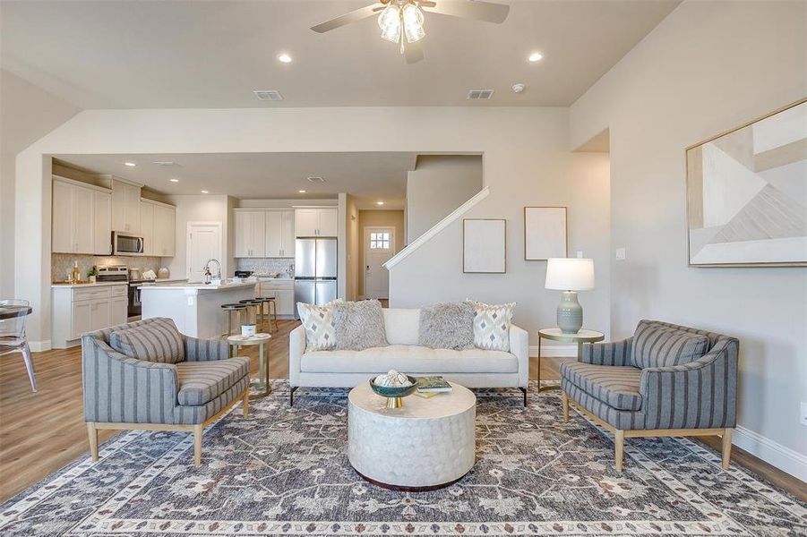 Living room featuring sink, ceiling fan, and hardwood / wood-style flooring