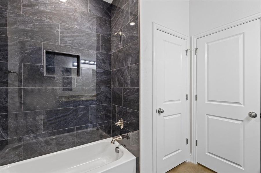 Bathroom featuring tiled shower / bath