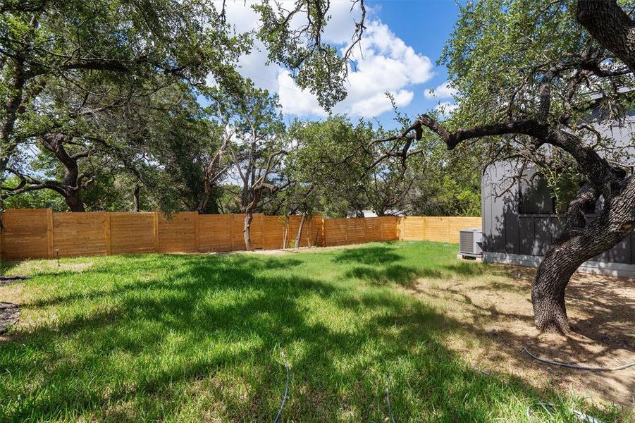 The yard likely features lush greenery, as the area is known for large oak trees and close proximity to nature.