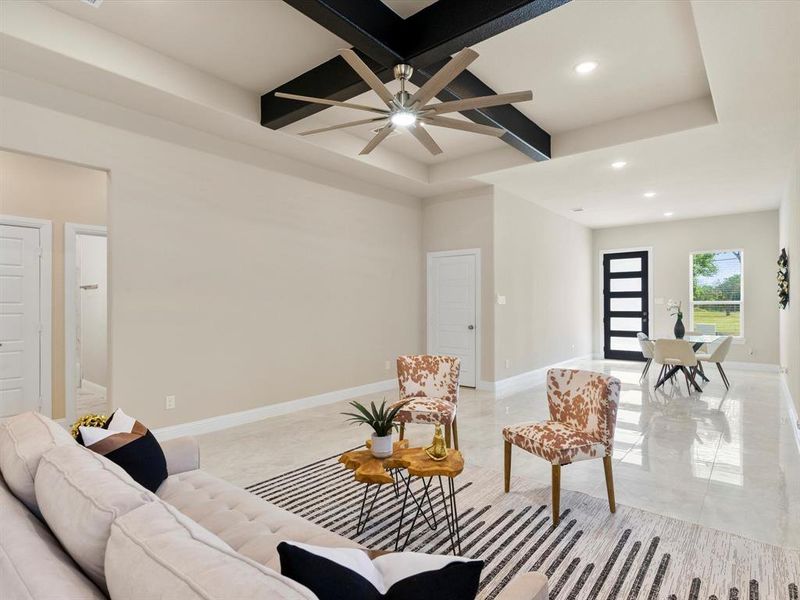 Living room with ceiling fan and beamed ceiling