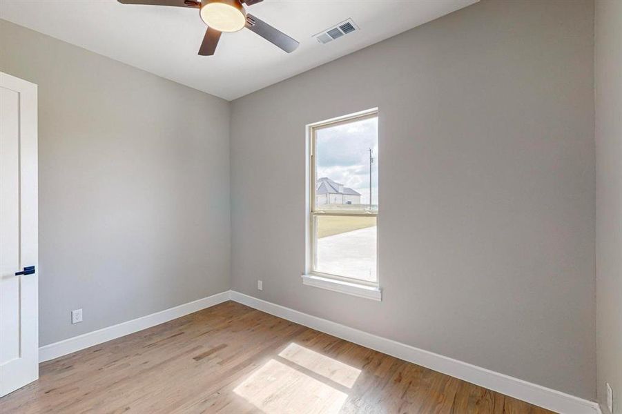 Spare room featuring light hardwood / wood-style flooring and ceiling fan