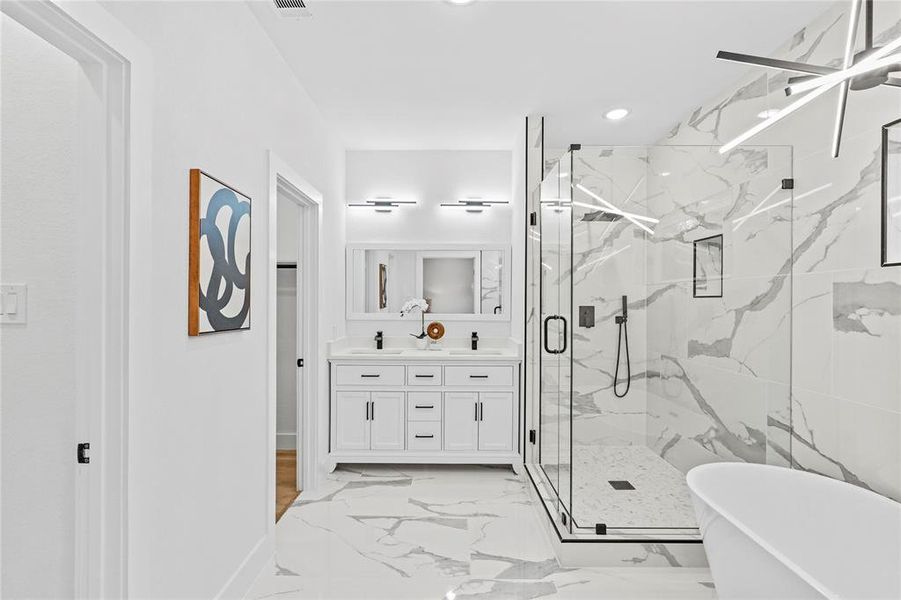 Bathroom featuring vanity and plus walk in shower