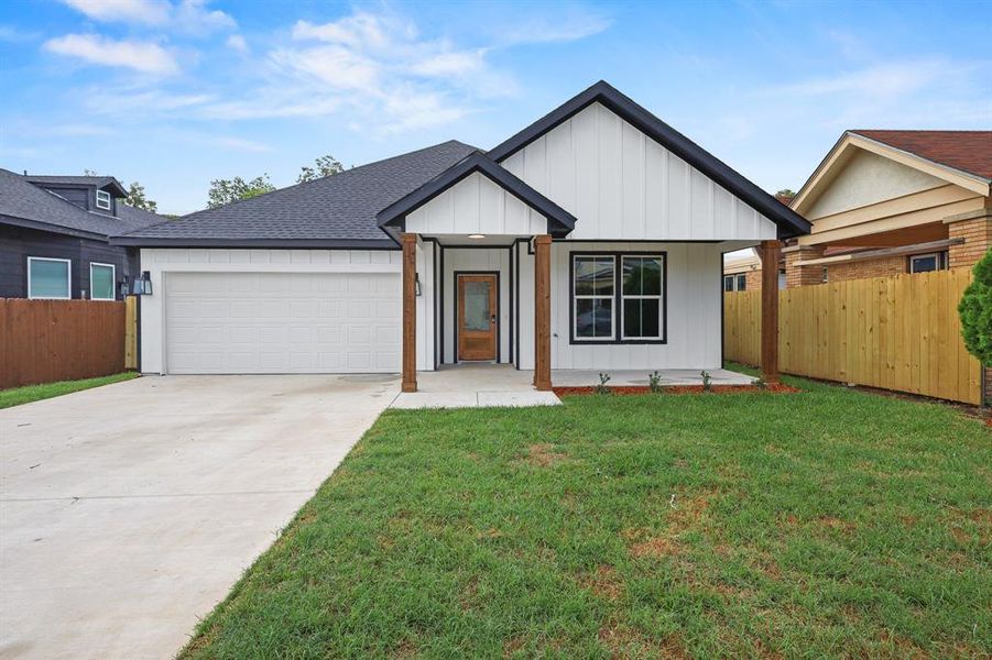 View of front of home featuring a garage and a front lawn