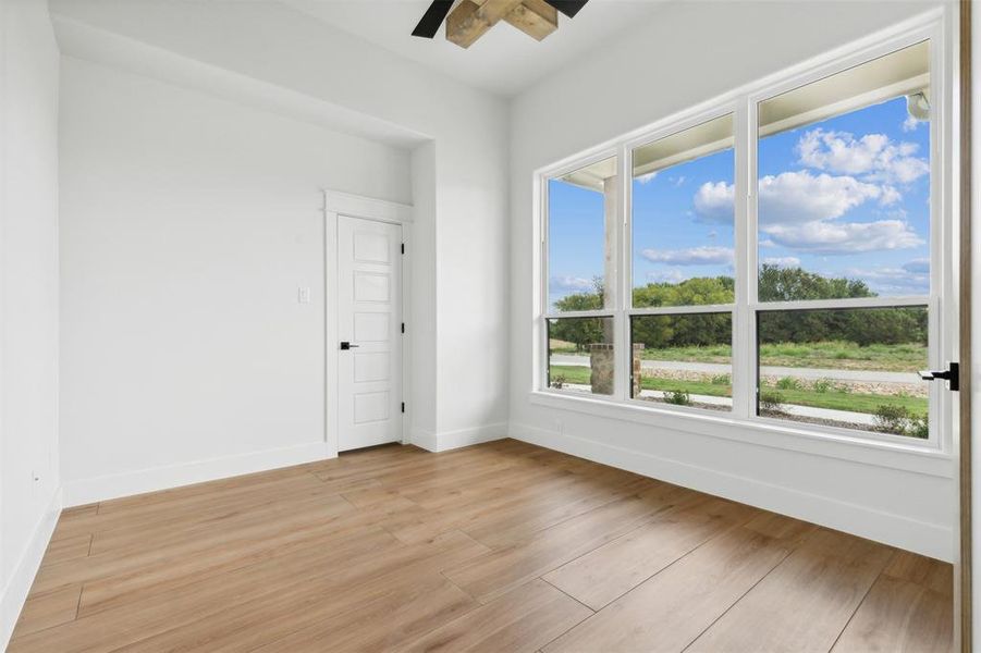 Spare room with ceiling fan and light hardwood / wood-style floors