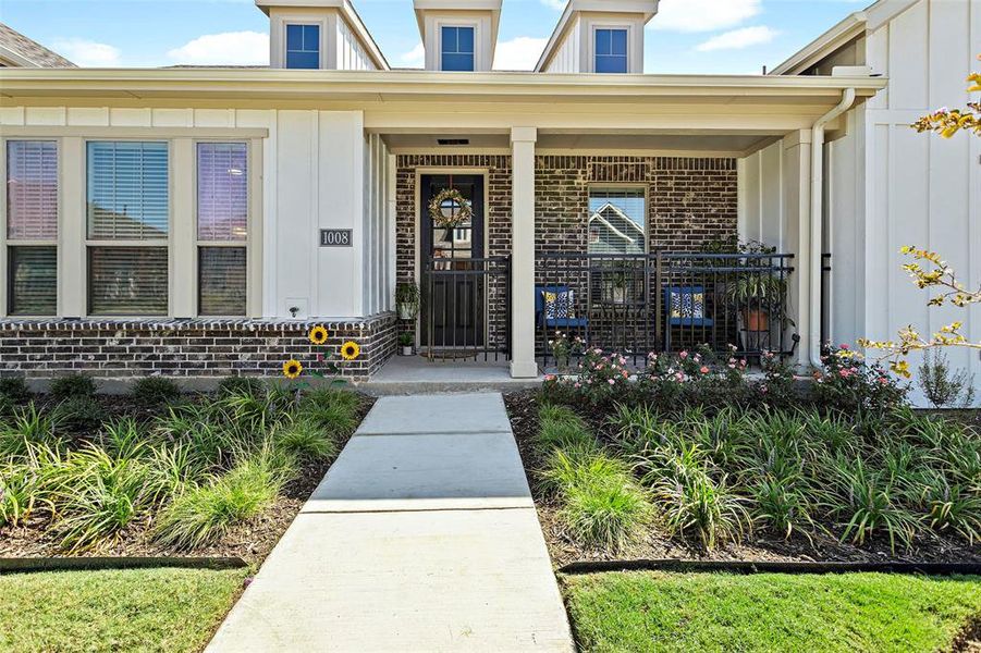 Entrance to property featuring covered porch