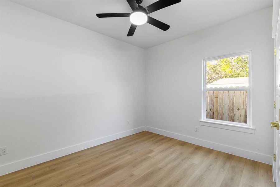 Empty room featuring ceiling fan and light hardwood / wood-style flooring