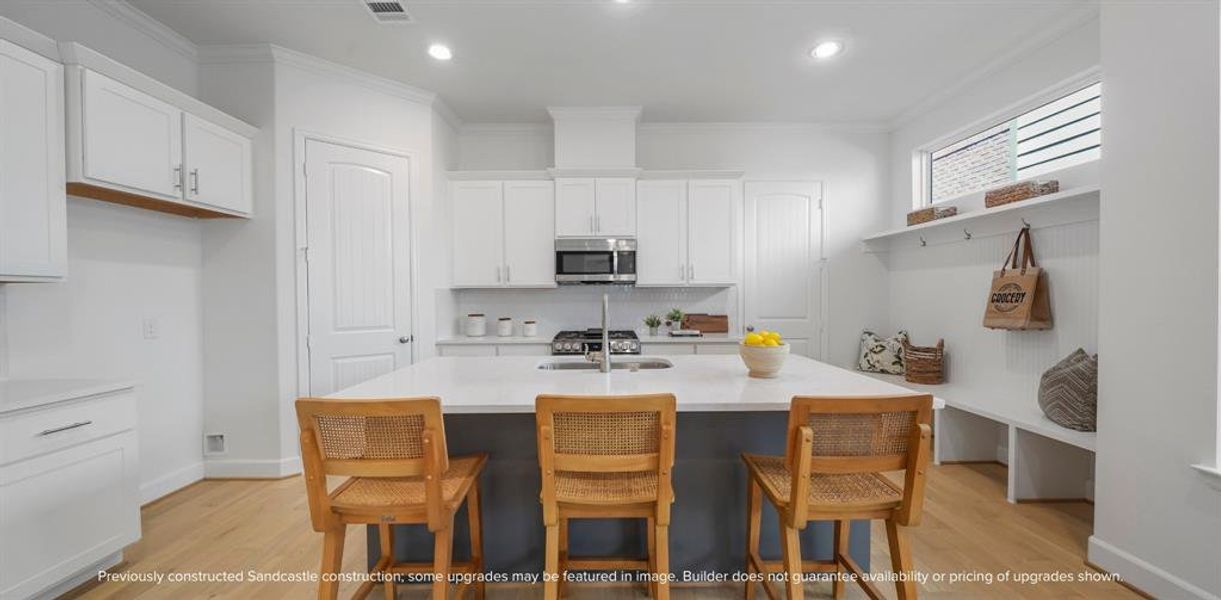 Culinary Excellence: Centered around a generous kitchen island, this modern chef's paradise boasts the latest in sleek stainless steel appliances from LG or Bosch, marrying function with sophistication.