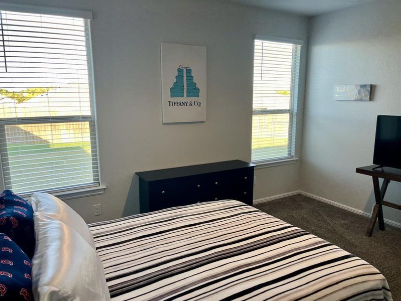 Bedroom featuring dark colored carpet