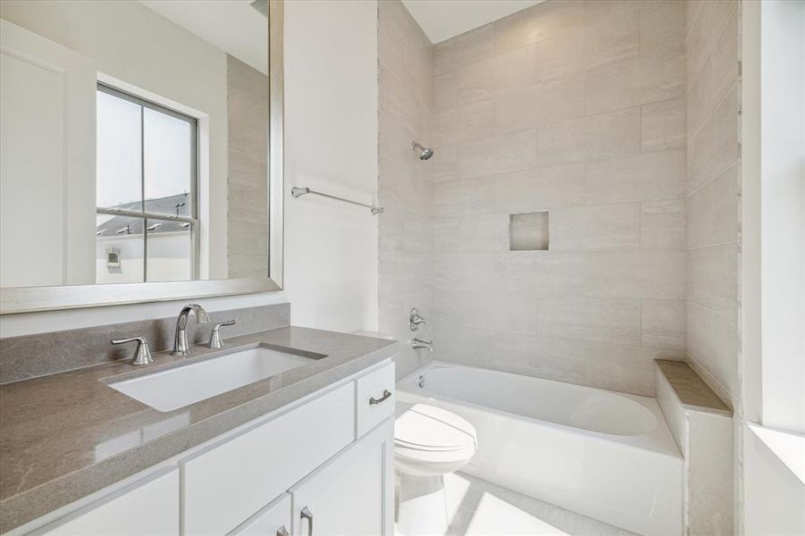 En suite bathroom with large window providing natural light.