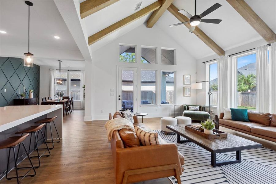 Note the emerald accent wall adjacent the kitchen, highlighting the dining area.