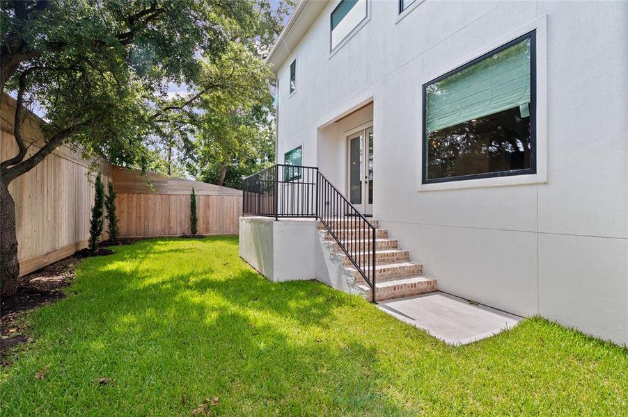 The backyard has extra tall fence for added privacy.