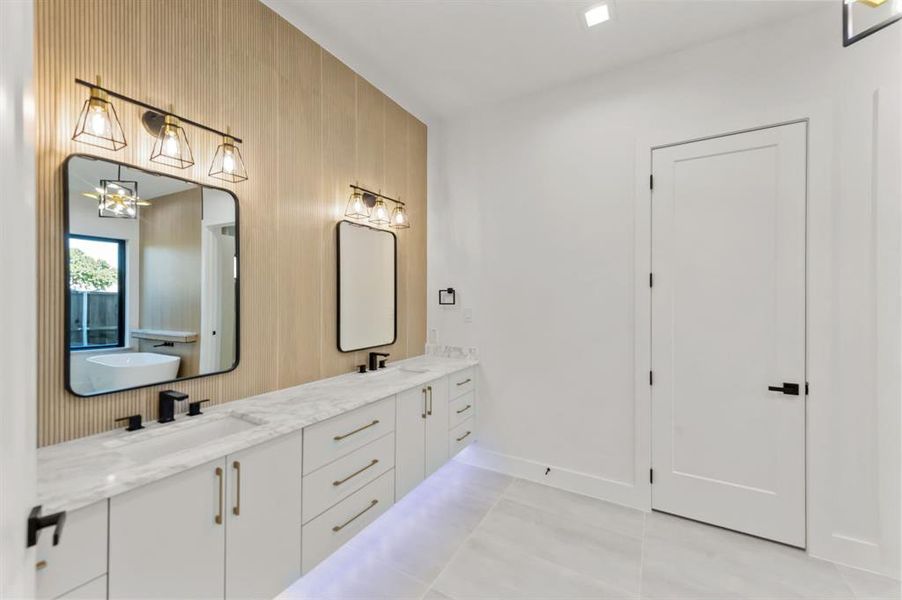 Master Bathroom with tile patterned flooring, vanity, and a notable chandelier