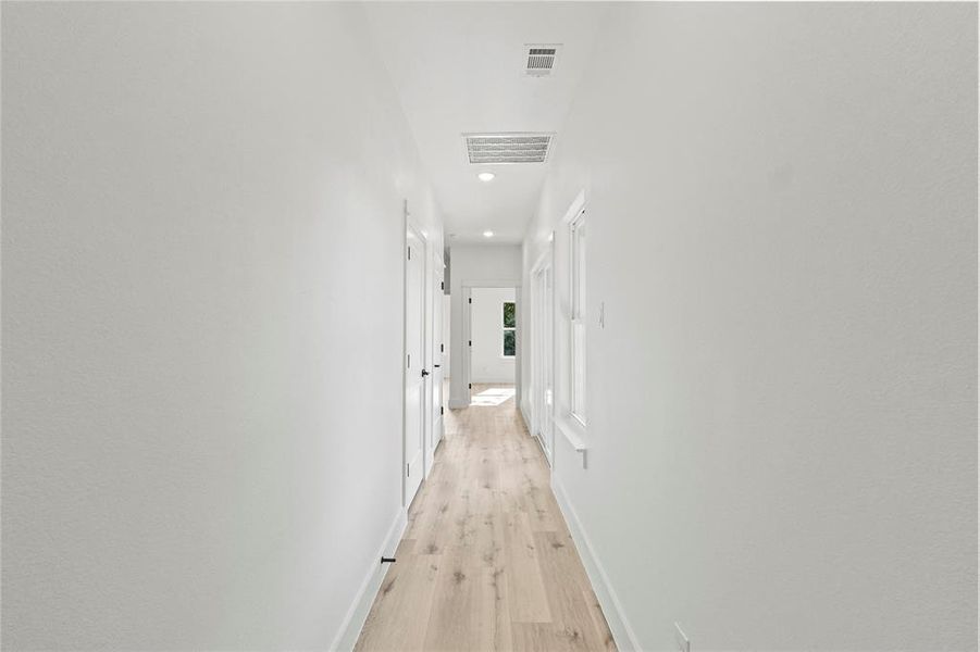 Corridor featuring light wood-type flooring