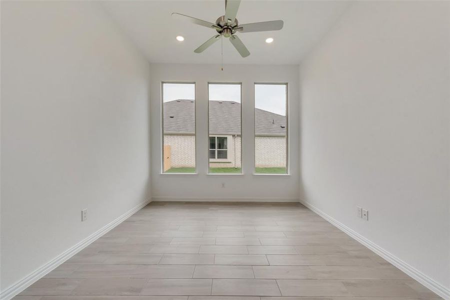 Spare room with ceiling fan and light hardwood / wood-style floors