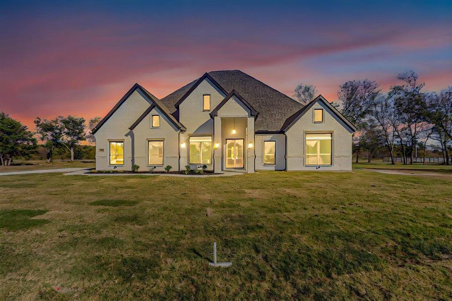 View of front of home with a yard