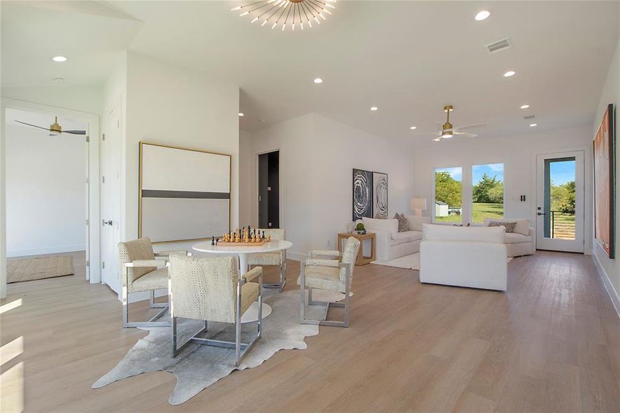 Dining area with light hardwood / wood-style flooring and ceiling fan