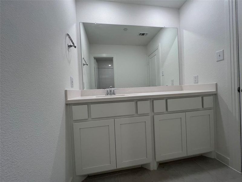 Bathroom featuring tile flooring and vanity