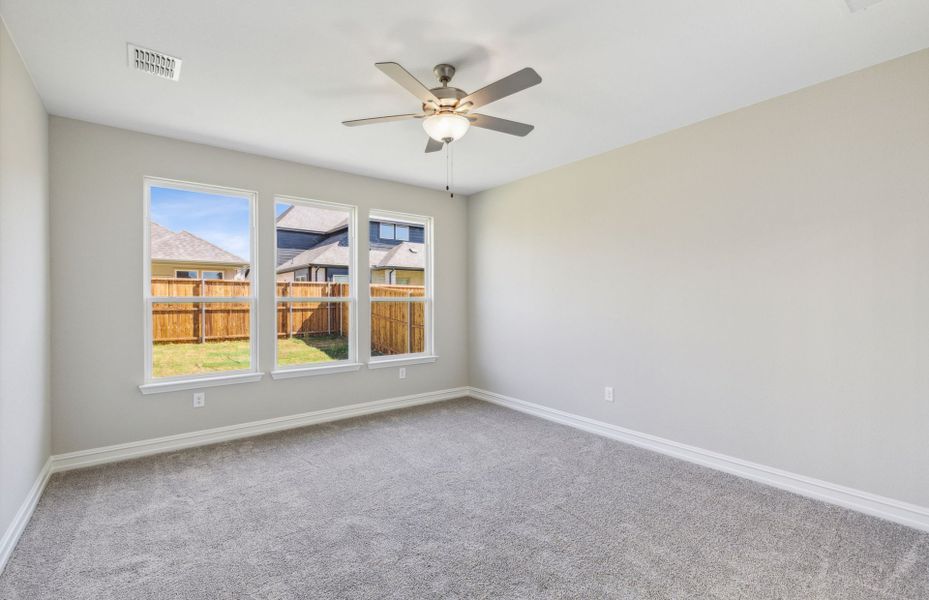 Elegant owner's suite with large windows and private bathroom