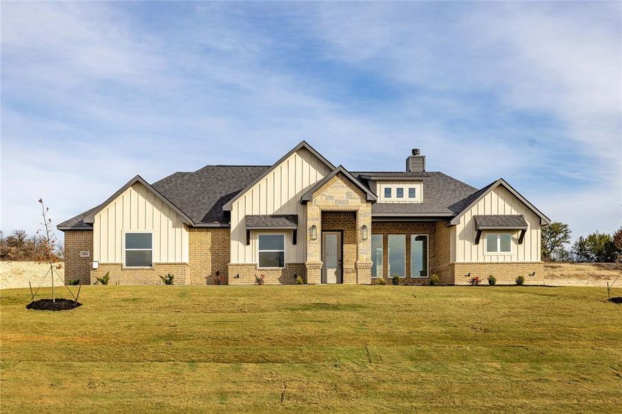 Modern inspired farmhouse with a front yard