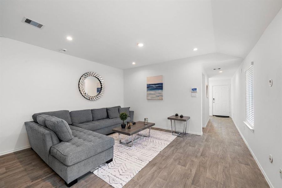 This modern, well-lit living room features recessed lighting, a spacious layout, with contemporary furnishings. The furniture is for sale, per the seller.
