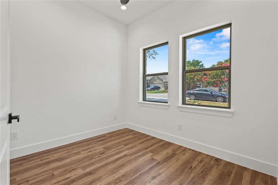 Spare room with a healthy amount of sunlight and wood-type flooring