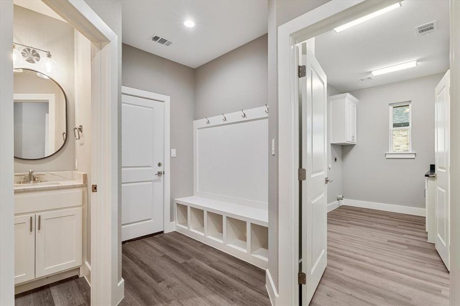 Mudroom featuring hardwood / wood-style flooring and sink