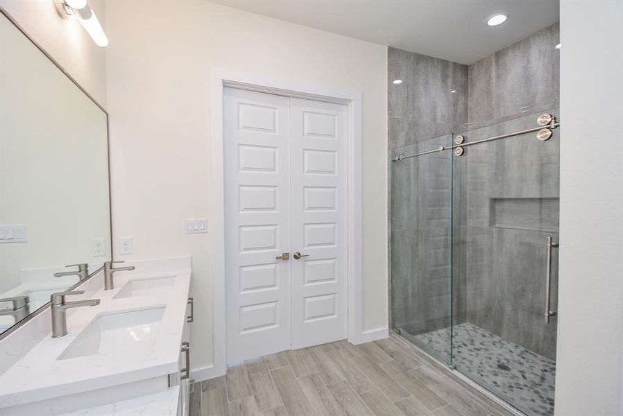 Master suite shower with tiled walls throughout and sliding door.