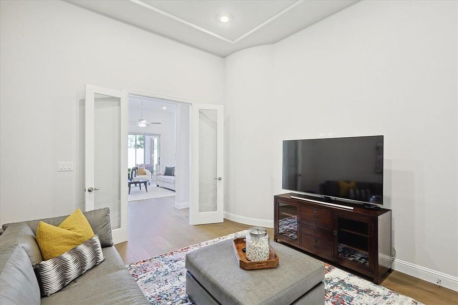 Living room with french doors, wood-type flooring, and ceiling fan