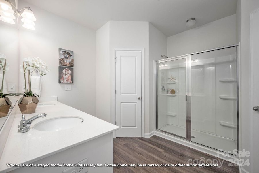 Primary bathroom with dual sinks and large shower