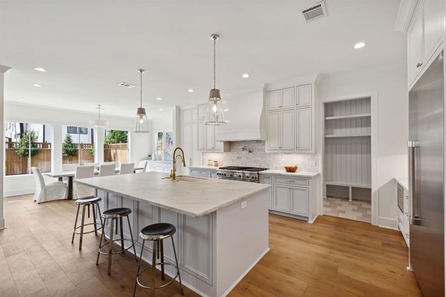 A wonderful floorplan with a large dining area adjacent to the kitchen with expansive windows overlooking the covered patio and backyard.