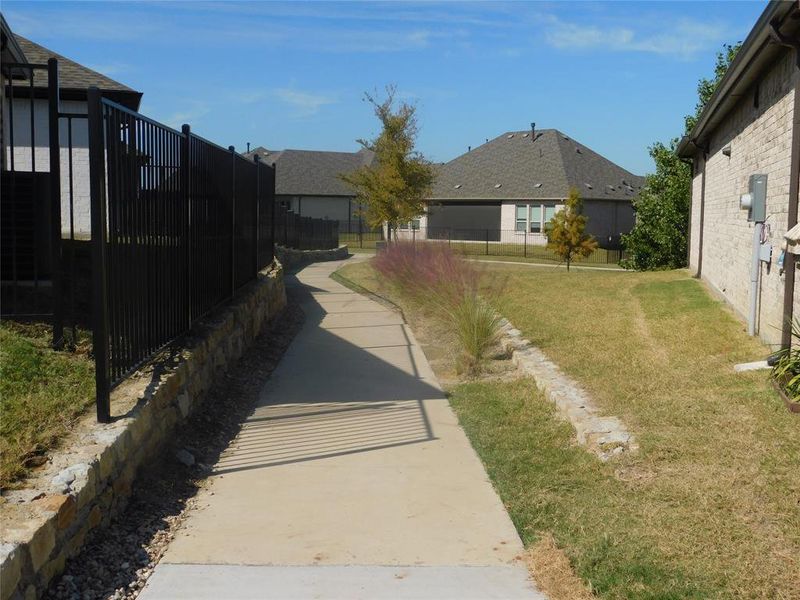 Side view of home featuring a walking path