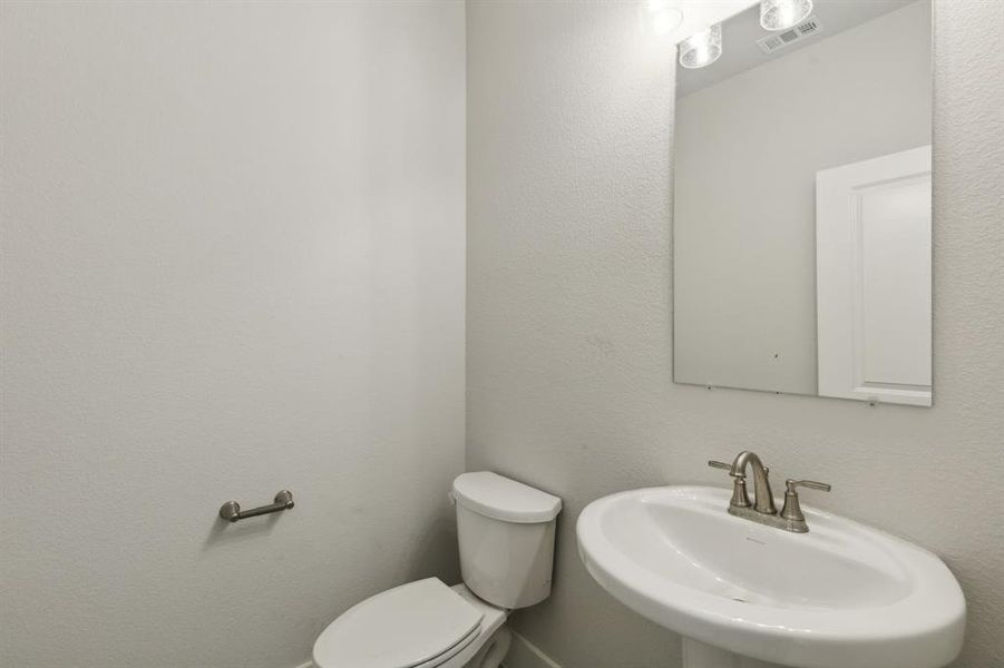 Bathroom featuring toilet and sink