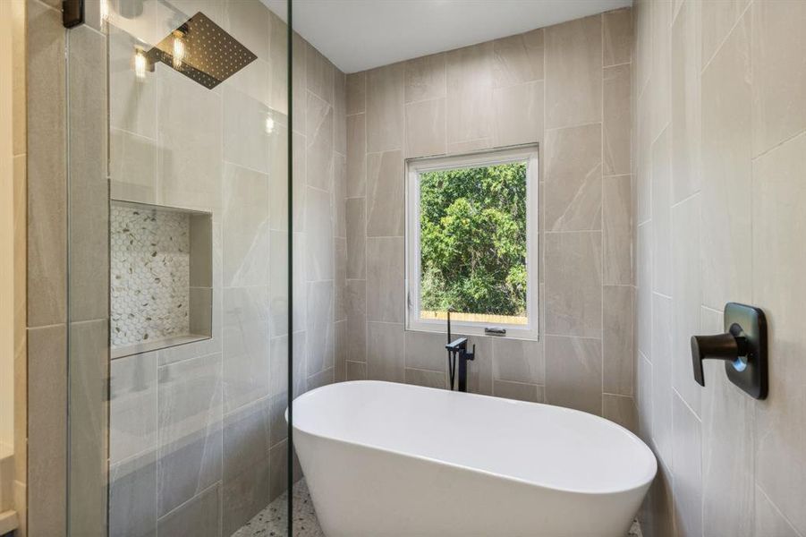 Wet room shower and slipper tub in the primary ensuite bath.