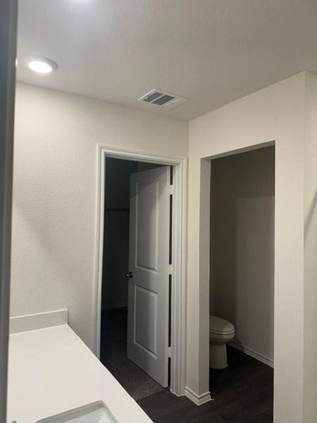 Bathroom with hardwood / wood-style floors and toilet