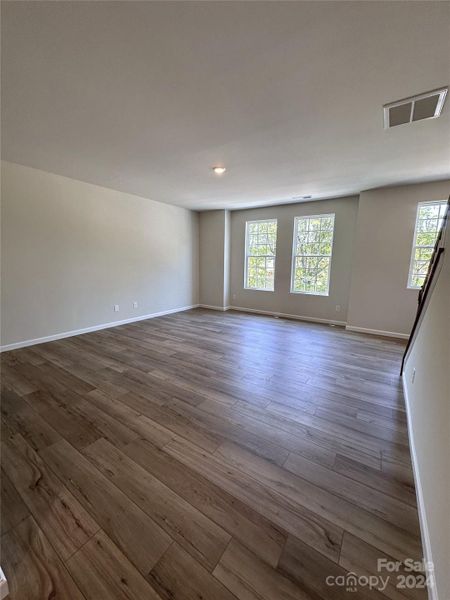 THE SECOND FLOOR FEATURES A LARGE LIVING ROOM WITH 9 FT CEILING AND LUXURY VINYL PLANK FLOORING THROUGHOUT.