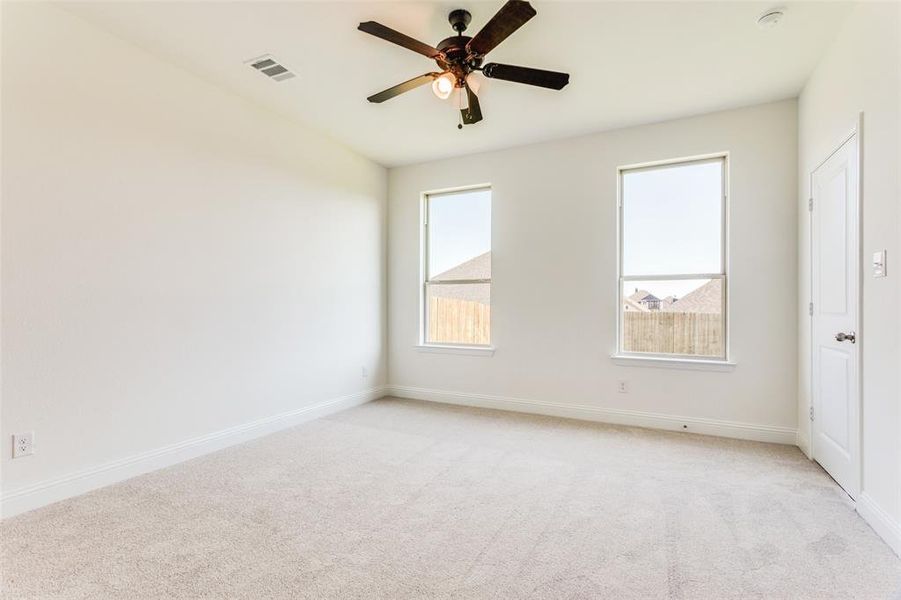 Unfurnished room with light carpet and ceiling fan