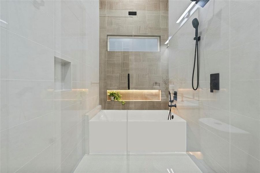 Bathroom featuring shower with separate bathtub