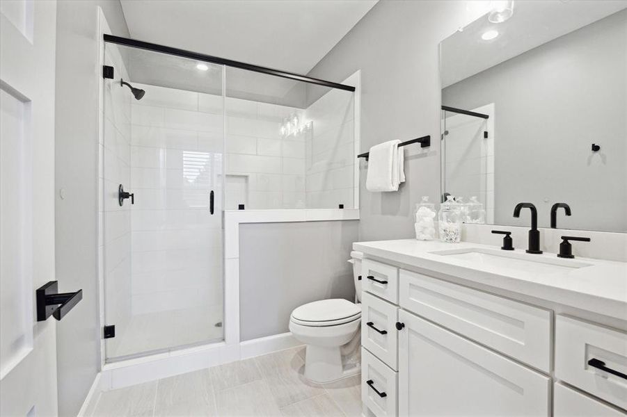 Secondary bathroom with tile floor, recessed lighting, single sink, and tub/shower combo.
