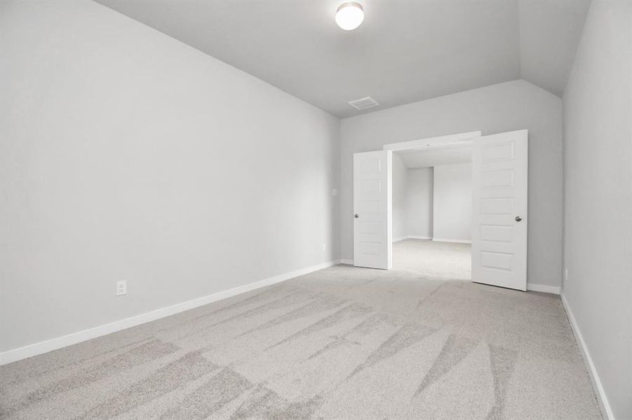 Adjacent to the game room, are the doors to enter into your own media room. Ideal for staying in on weekends and enjoying a film within the comfort of your home. Sample photo of completed home with similar floor plan. As-built interior colors and selections may vary.