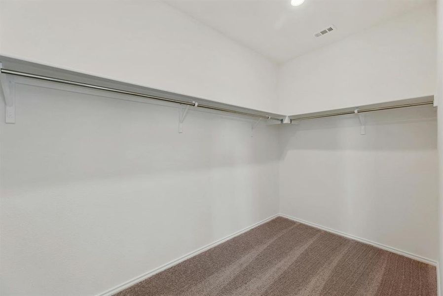 Spacious walk-in closet providing ample storage and organization, perfect for keeping your wardrobe tidy and accessible.