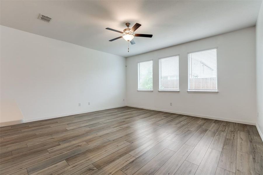 Unfurnished room with ceiling fan and wood-type flooring