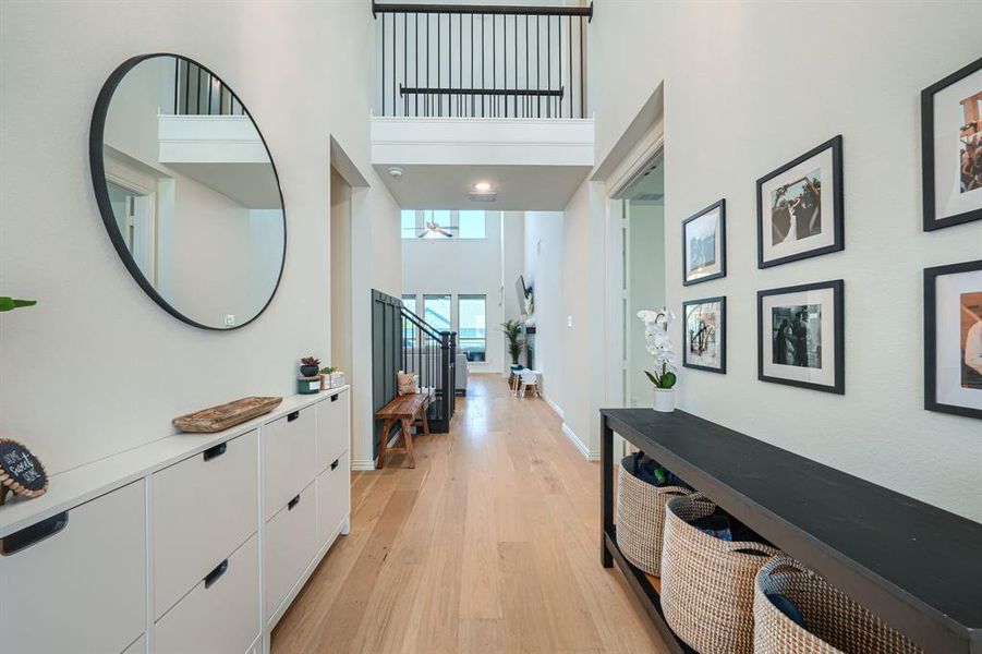 Foyer featuring a high ceiling and light hardwood / wood-style floors