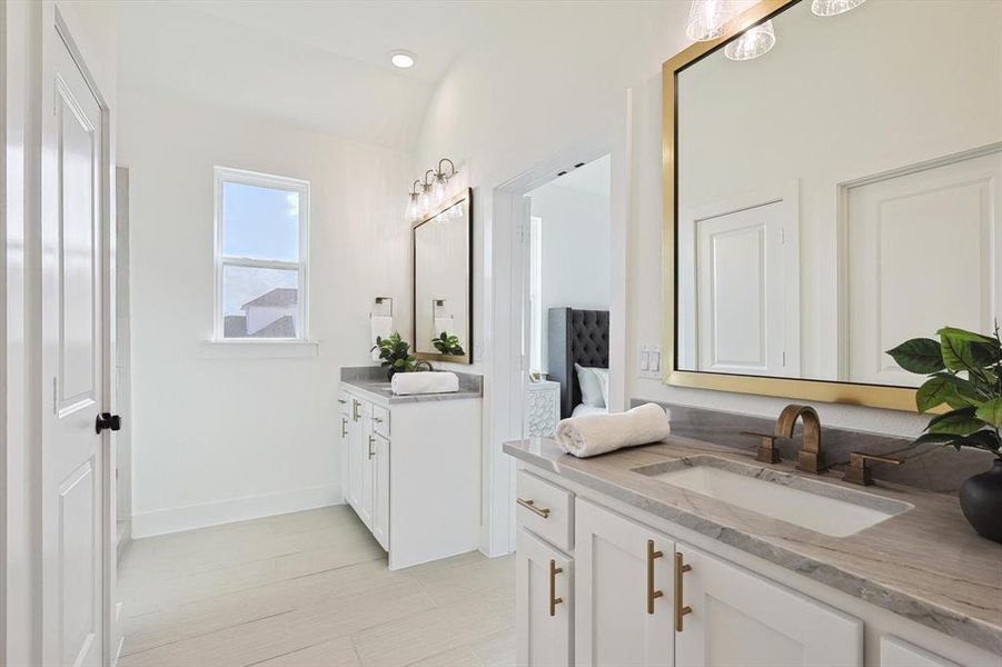 Bathroom featuring double vanity and tile floors