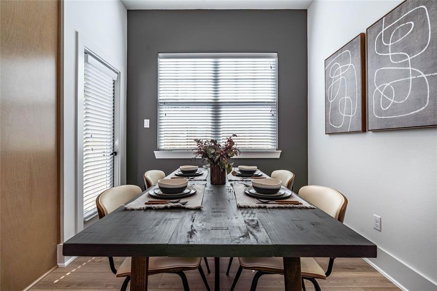 Another accent wall in the dining area enhances the flow of color and design throughout the first-floor living space.