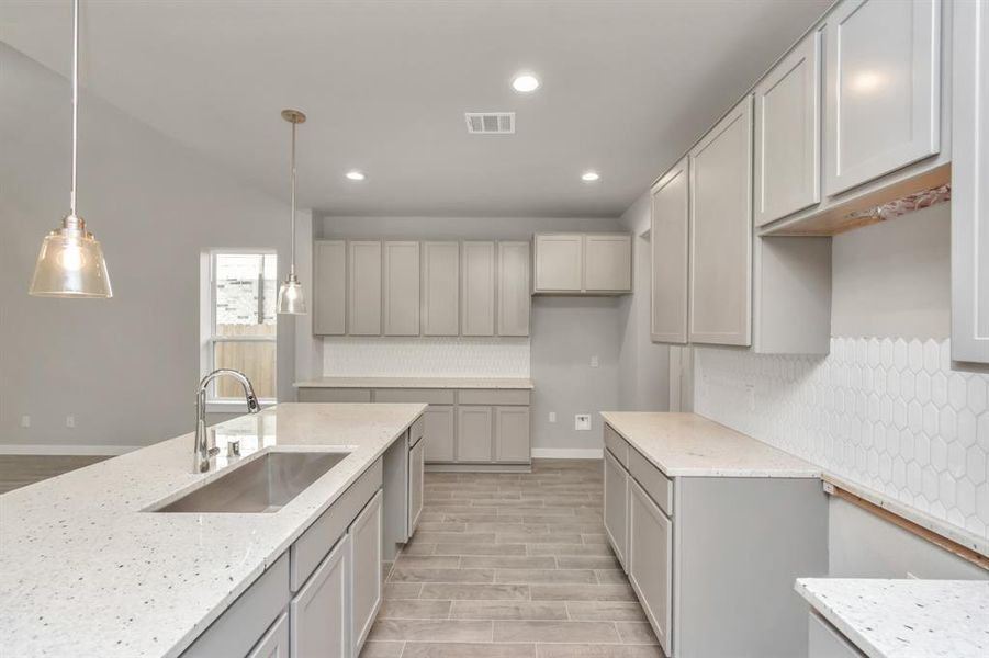 This generously spacious kitchen is a dream realized! Sample photo of completed home with similar floor plan. As built color and selections may vary.