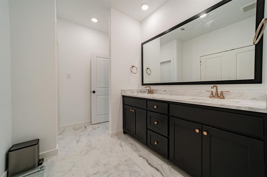 Bathroom featuring double vanity and tile patterned floors