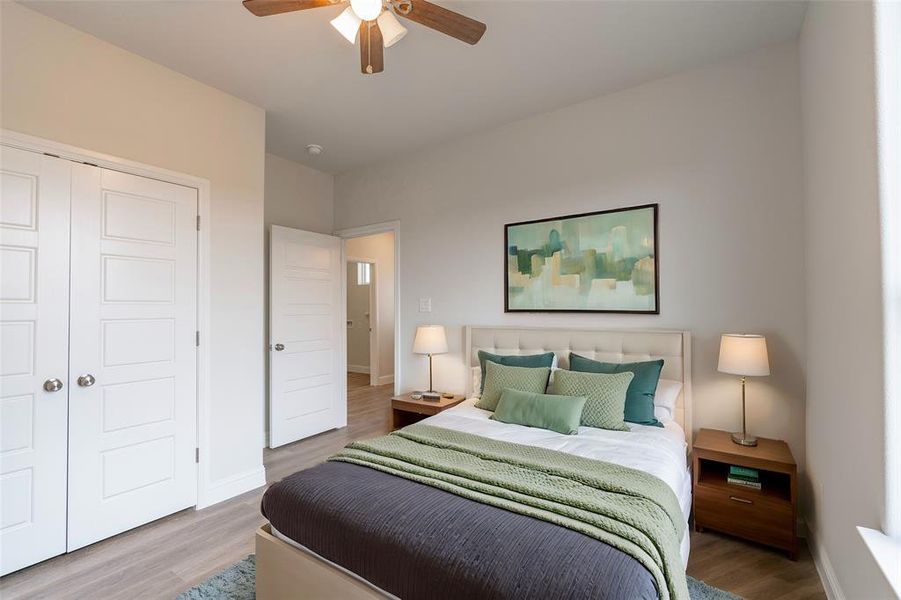 Bedroom with ceiling fan, a closet, and light wood-type flooring