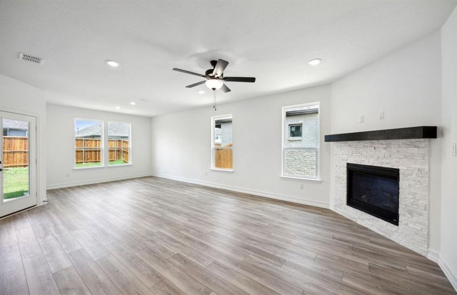 Bright gathering room with fireplace *real home pictured