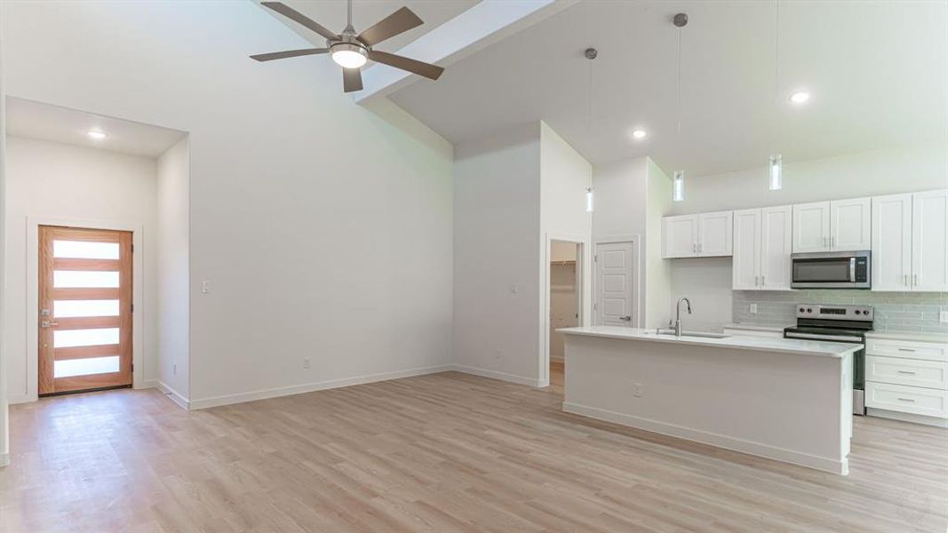 Living room with open concept kitchen and dining areas