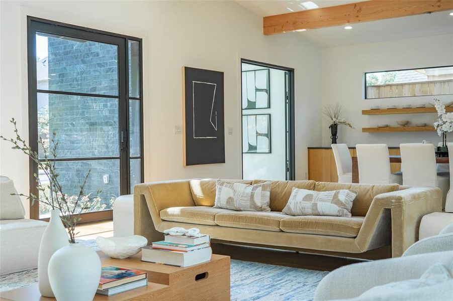 Living room with plenty of natural light and beam ceiling